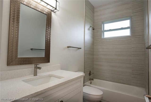 full bathroom featuring vanity, toilet, and tiled shower / bath