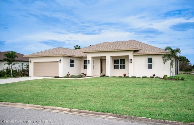 view of front of property with a garage and a front lawn