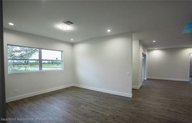 spare room with dark hardwood / wood-style floors