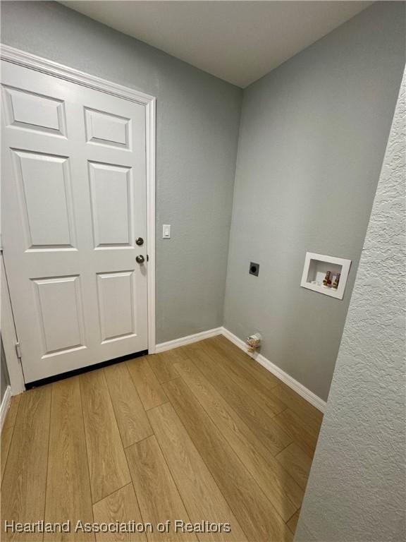 laundry room featuring washer hookup, hookup for an electric dryer, and light hardwood / wood-style floors