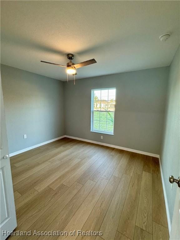 unfurnished room featuring ceiling fan and light wood-type flooring