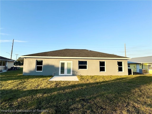 back of house featuring a lawn, cooling unit, and a patio area