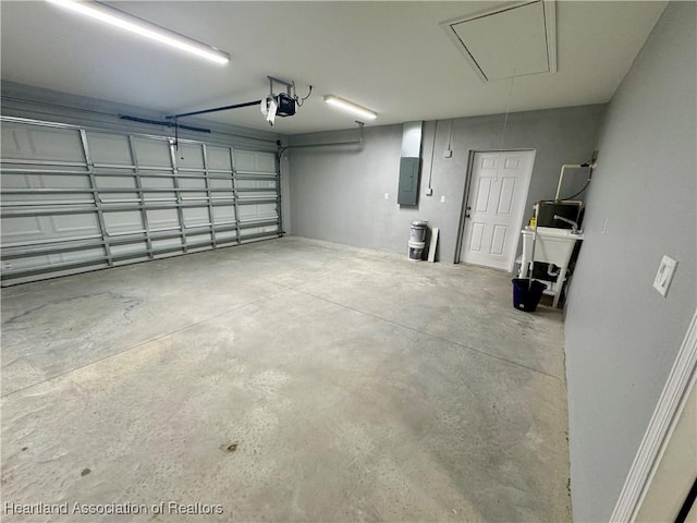 garage featuring electric panel and a garage door opener