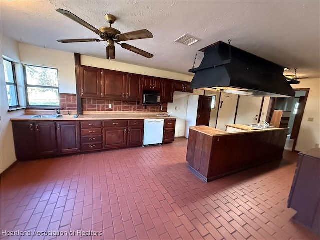 kitchen with white appliances, island exhaust hood, visible vents, and light countertops