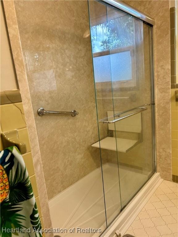 bathroom featuring a shower with door