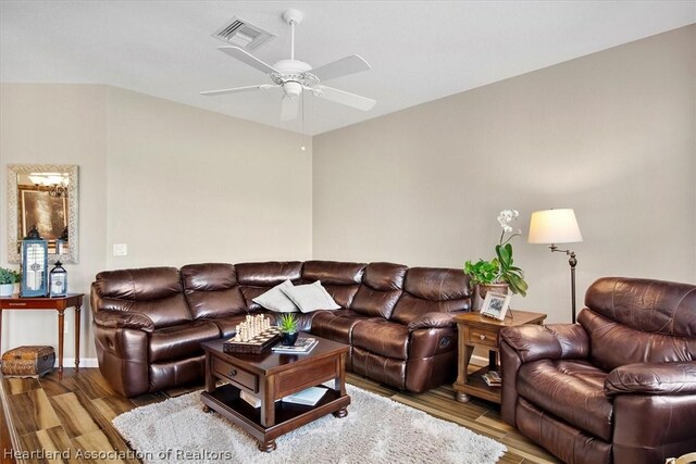 living room featuring hardwood / wood-style flooring and ceiling fan