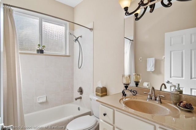 full bathroom featuring toilet, vanity, shower / tub combo with curtain, and a notable chandelier