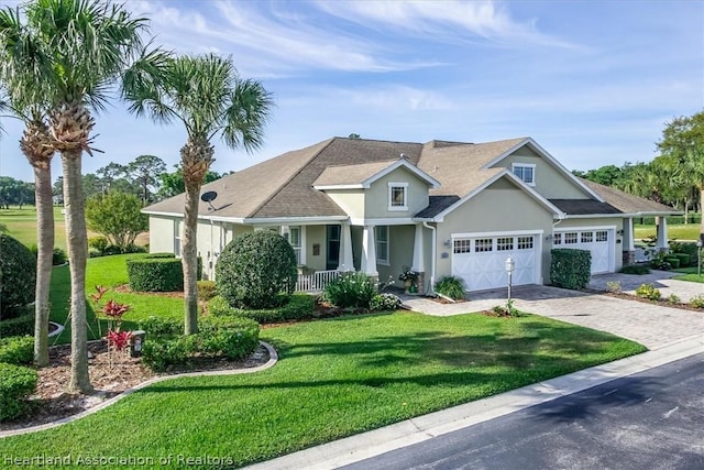 craftsman-style house with a porch, a front yard, and a garage