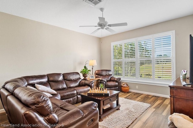 living room featuring ceiling fan and light wood-type flooring