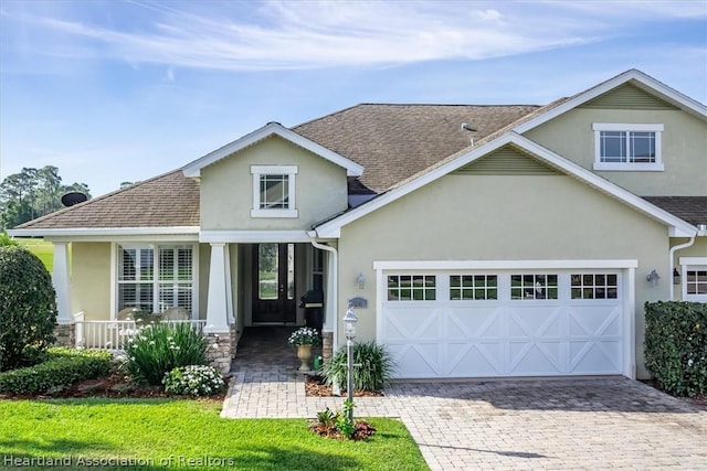 view of front of house featuring covered porch and a garage