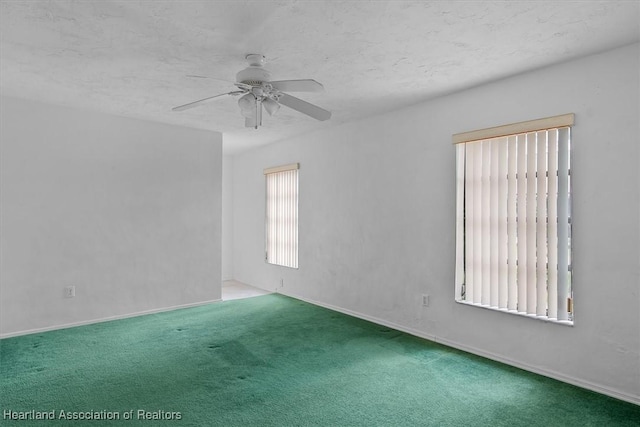 unfurnished room with carpet, ceiling fan, and a textured ceiling