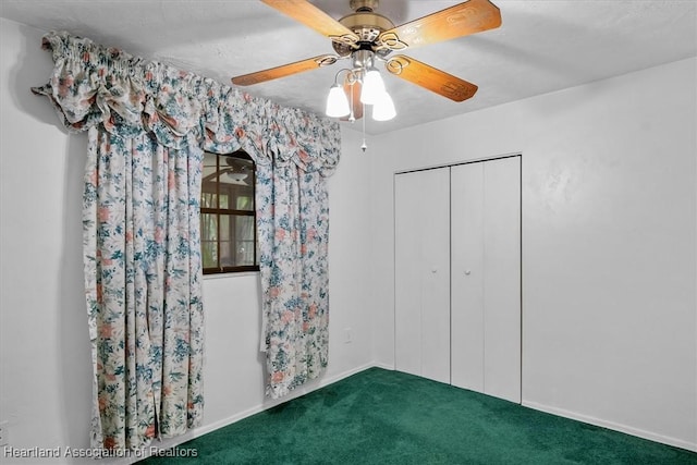 unfurnished bedroom featuring carpet flooring, ceiling fan, a closet, and a textured ceiling