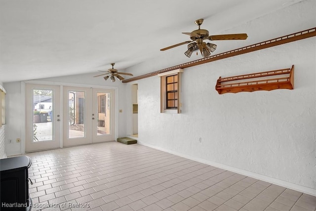 empty room with french doors, vaulted ceiling, and ceiling fan