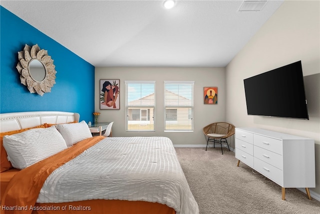 bedroom featuring light carpet, vaulted ceiling, visible vents, and baseboards