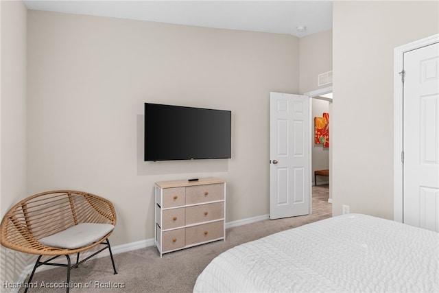 bedroom with carpet floors, visible vents, and baseboards