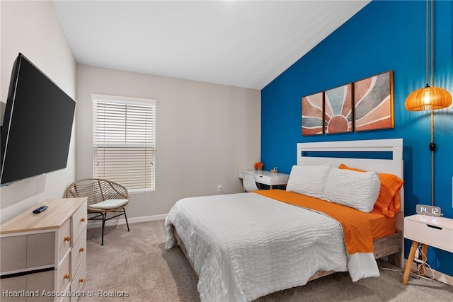 carpeted bedroom with lofted ceiling and baseboards