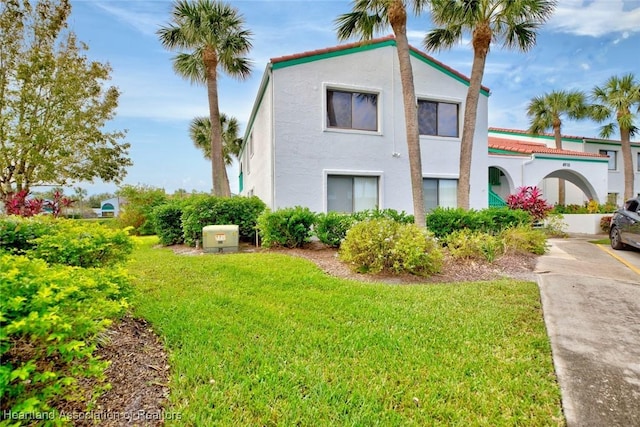 view of side of home with a yard