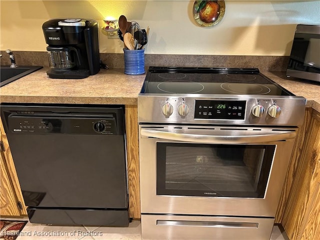 6000 Matanzas Dr, Sebring, FL 33872 - kitchen with black dishwasher, stainless steel electric range oven, light countertops, and a sink