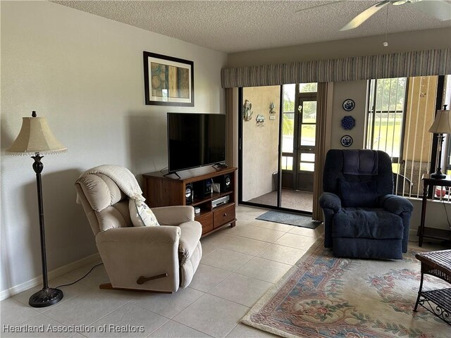 6000 Matanzas Dr, Sebring, FL 33872 - living area with a textured ceiling, light tile patterned flooring, ceiling fan, and baseboards