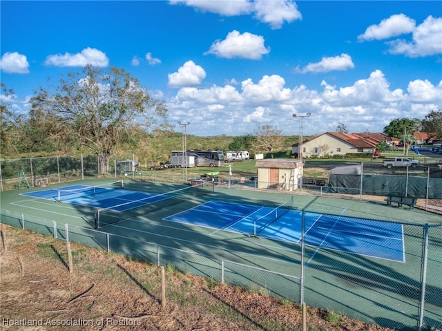 view of sport court with fence