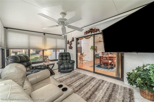 living room featuring light tile patterned floors and ceiling fan