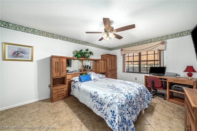 bedroom with ceiling fan, a textured ceiling, light tile patterned flooring, and baseboards