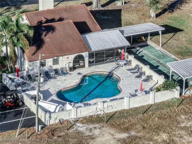 community pool featuring a patio and shuffleboard