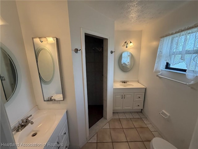 4329 Elson Ave, Sebring, FL 33875 - full bathroom with plenty of natural light, tile patterned flooring, a textured ceiling, two vanities, and a shower