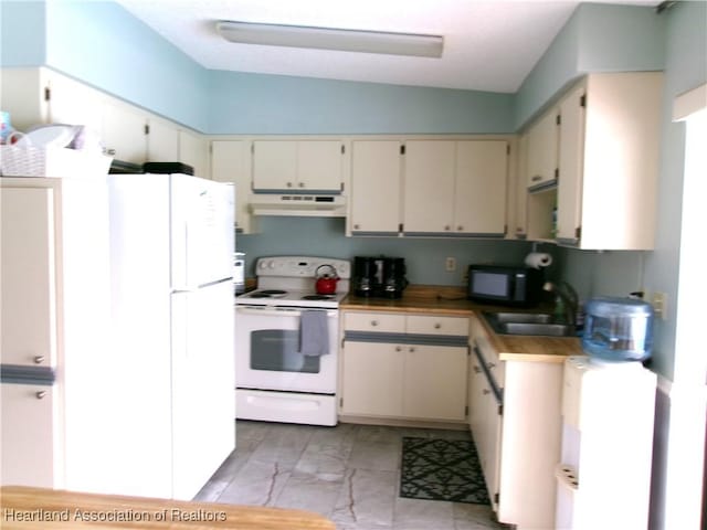 kitchen with sink, white appliances, and cream cabinetry