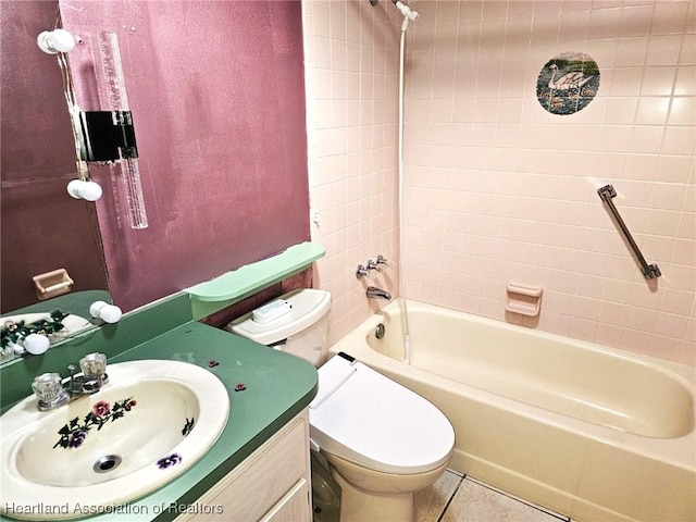 full bathroom with tile patterned flooring, vanity, toilet, and tiled shower / bath