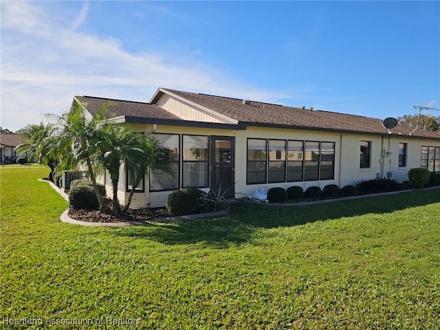 view of side of home with a lawn