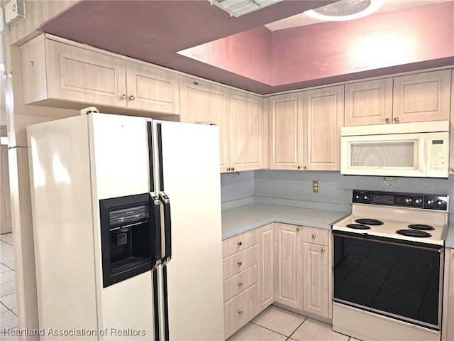 kitchen with light tile patterned floors and white appliances