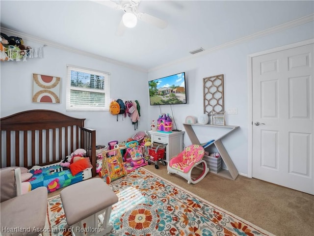 bedroom with ceiling fan, carpet floors, and ornamental molding