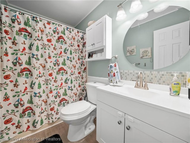 bathroom with tasteful backsplash, hardwood / wood-style floors, toilet, vanity, and ornamental molding