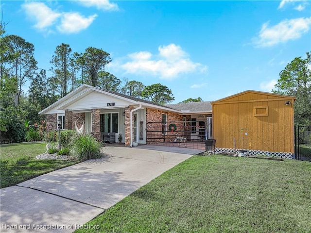 ranch-style house with a front yard and a storage shed