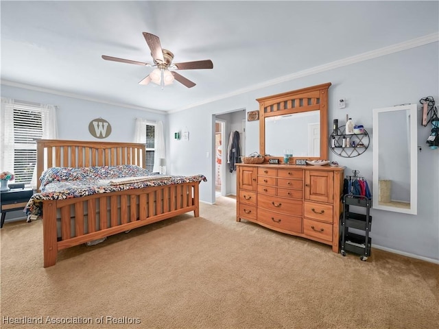 carpeted bedroom featuring ceiling fan and ornamental molding