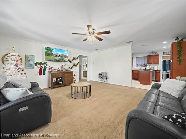 carpeted living room featuring ceiling fan and ornamental molding