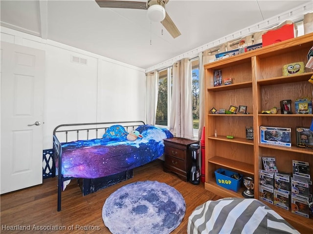 bedroom with ceiling fan and dark wood-type flooring