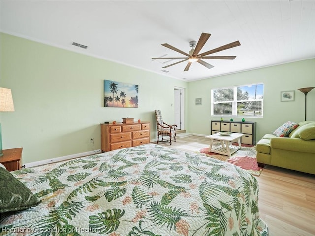 bedroom with light hardwood / wood-style flooring and ceiling fan