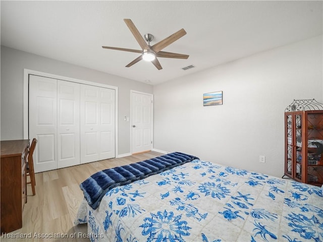 bedroom featuring wood-type flooring, a closet, and ceiling fan