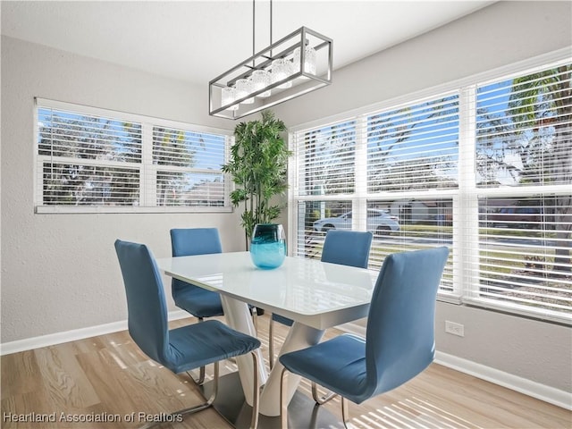 dining area with light wood-type flooring and a wealth of natural light