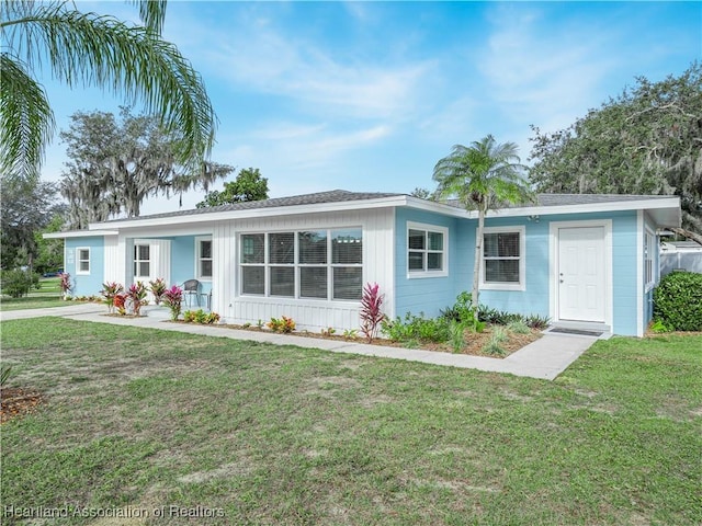 ranch-style home featuring a front yard