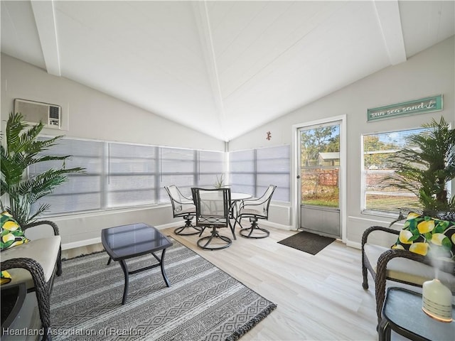 interior space featuring a wall mounted air conditioner and vaulted ceiling