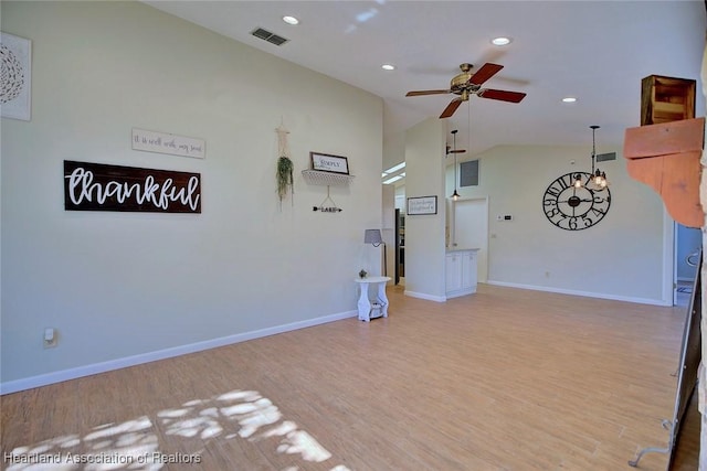 interior space featuring ceiling fan, lofted ceiling, and light wood-type flooring