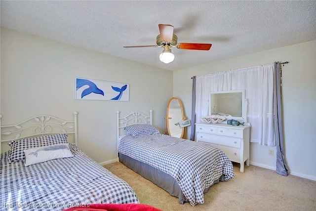 bedroom with ceiling fan, light carpet, and a textured ceiling