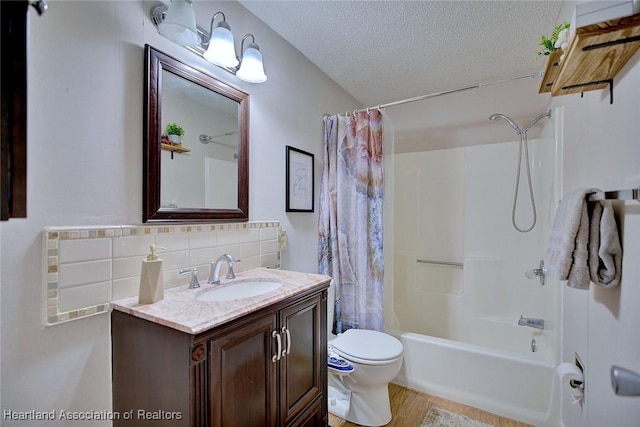 full bathroom with vanity, decorative backsplash, toilet, shower / bathtub combination with curtain, and a textured ceiling