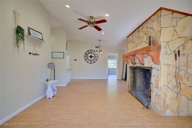 unfurnished living room with a fireplace, light hardwood / wood-style flooring, ceiling fan, and lofted ceiling