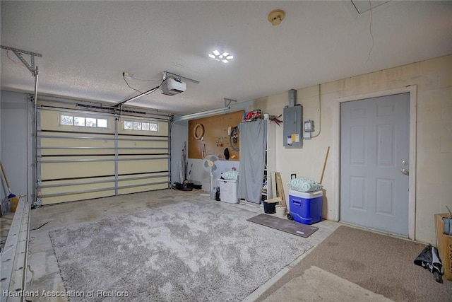 garage featuring electric panel and a garage door opener