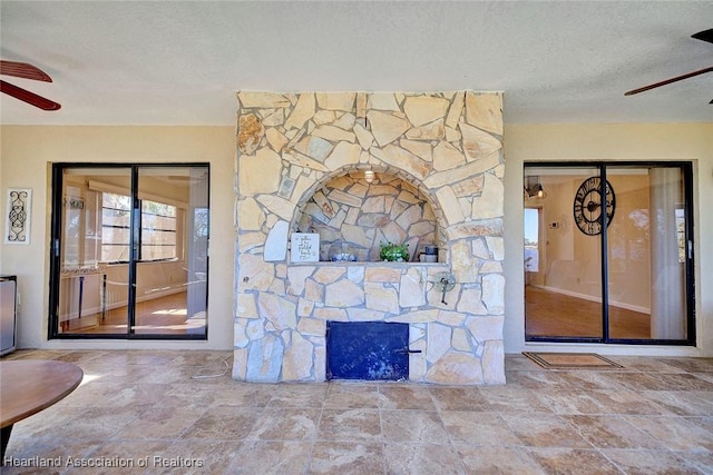 details featuring ceiling fan and a textured ceiling