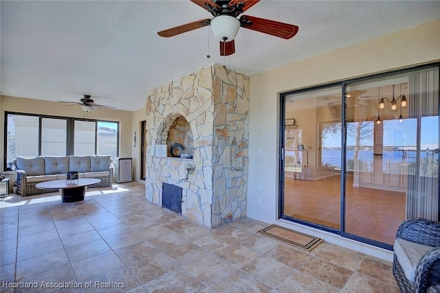 living room with a textured ceiling and ceiling fan